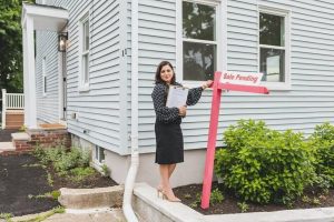 woman standing beside a sign